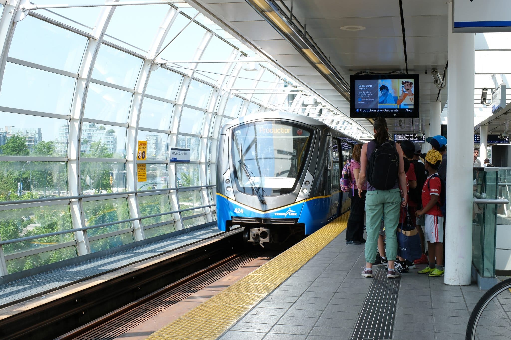 Canada Vancouver 03.22.2024 metro station waterfront delayed Delay Skytrain People waiting on the platform Blue line Skytrain train runs from waterfront to King's George